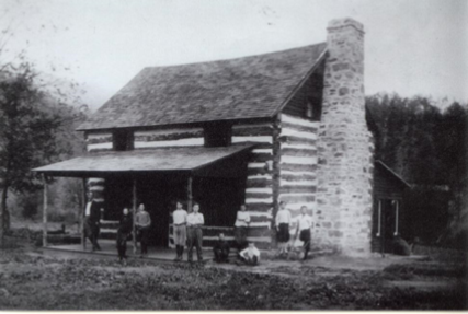 A black and white photo of the first residential cottage and school space on campus