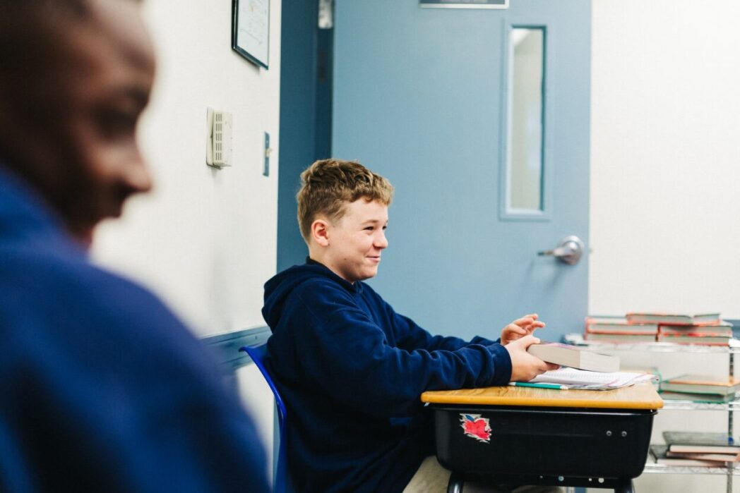 student in classroom desk ready to learn