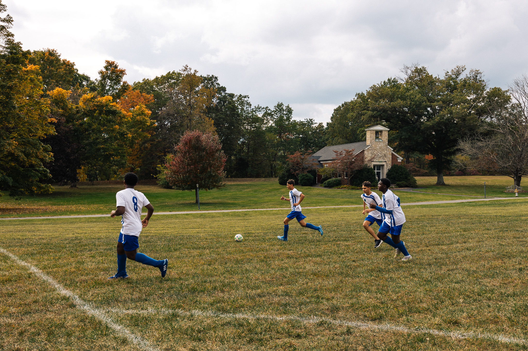 students on the field playing soccer 